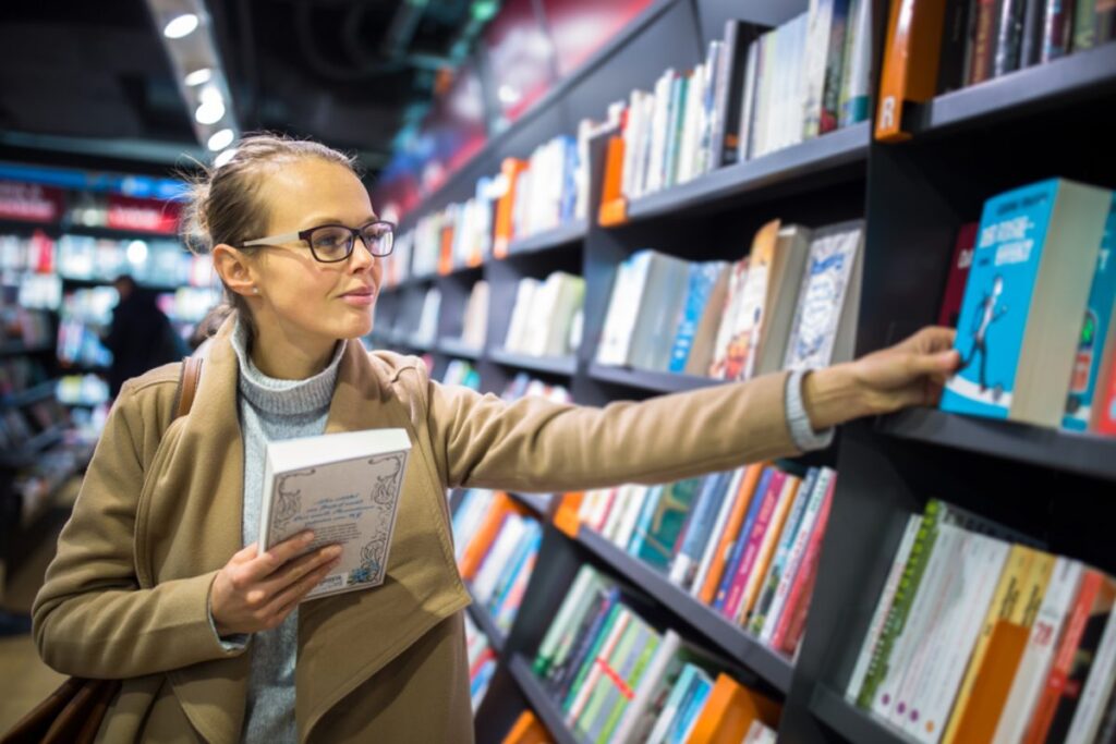 Mlada devojka razgleda i bira knjige
