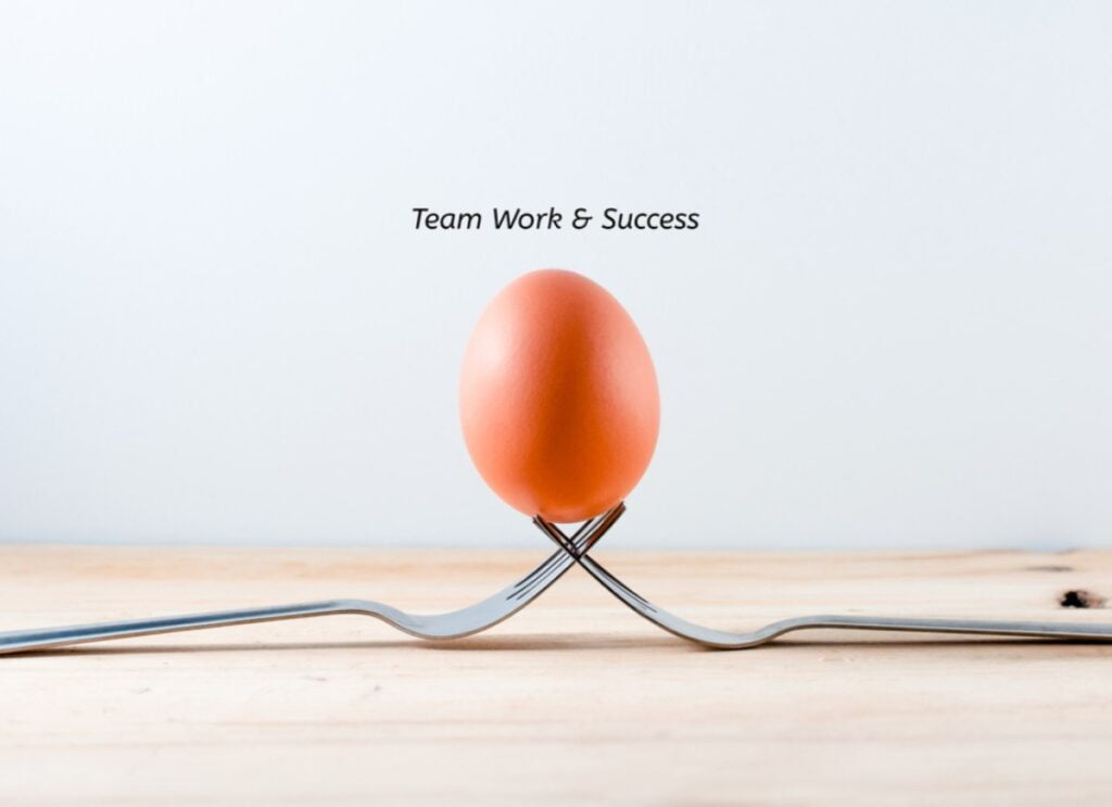 Jaje koje drže dve viljuške- simbol timskog uspeha