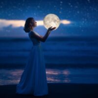 Devojka drži mesec u rukama, u noći