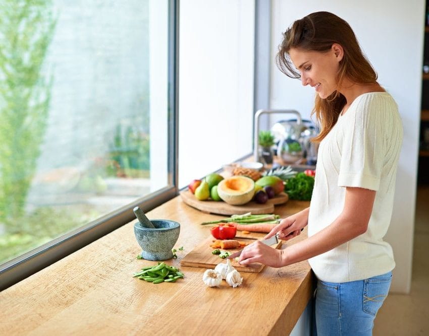 Žena koja sprema hranu u kuhinji.