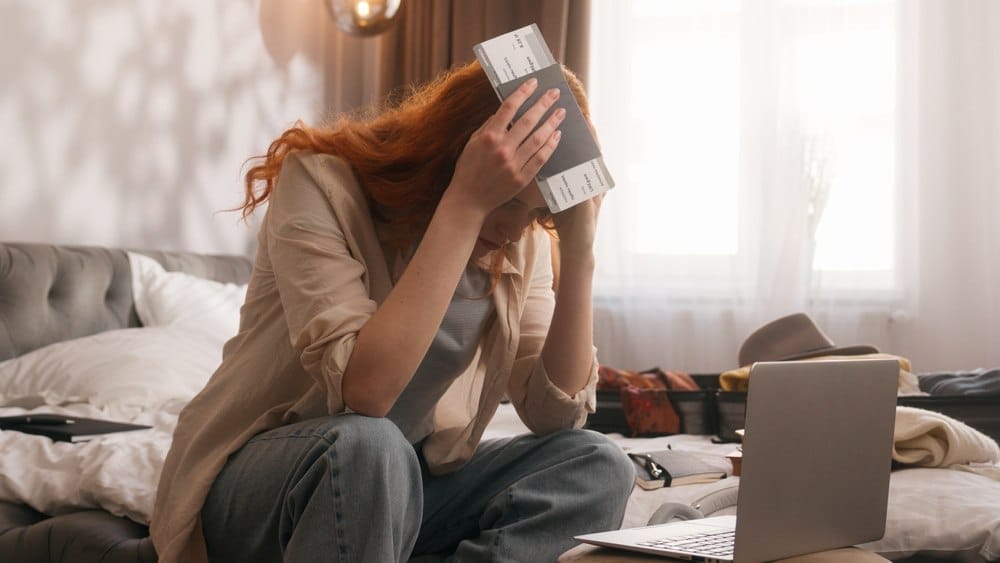 Putnica sedi u hotelu, drži pasoš, uhvatila se za glavu, letovi otkazani...